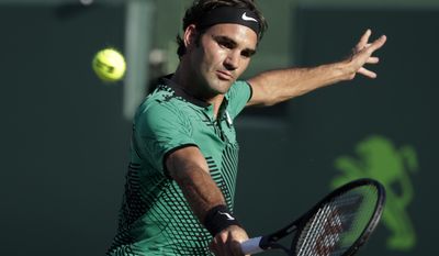 Roger Federer, of Switzerland, hits a return to Roberto Bautista Agut, of Spain, during the Miami Open tennis tournament, Tuesday, March 28, 2017, in Key Biscayne, Fla. (AP Photo/Lynne Sladky)