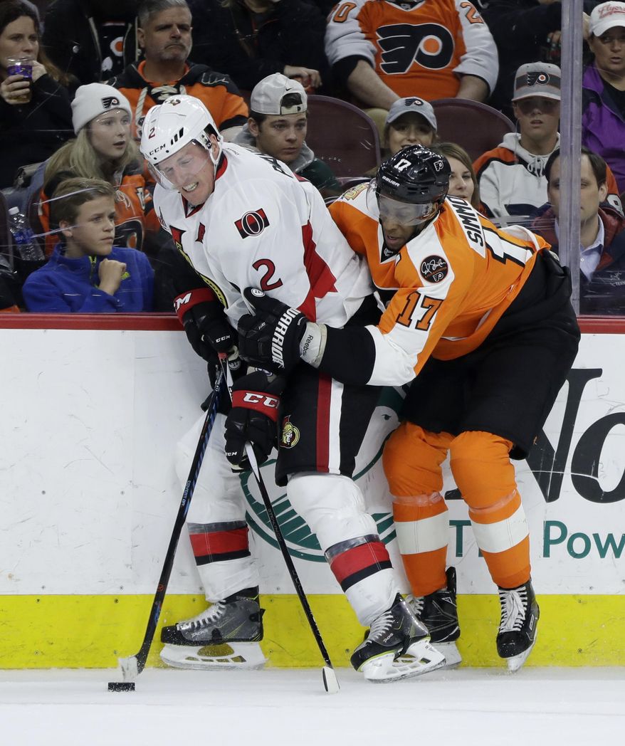 Philadelphia Flyers' Wayne Simmonds, right, hangs onto Ottawa Senators' Dion Phaneuf during the second period of an NHL hockey game, Tuesday, March 28, 2017, in Philadelphia. (AP Photo/Matt Slocum)