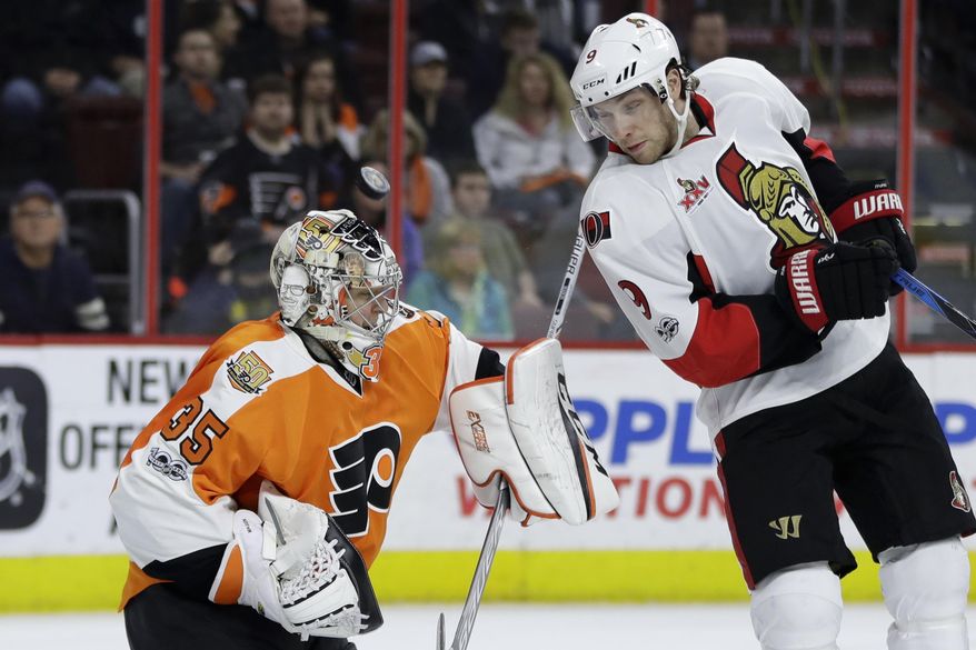 Philadelphia Flyers' Steve Mason, left, blocks a shot past Ottawa Senators' Bobby Ryan during the first period of an NHL hockey game, Tuesday, March 28, 2017, in Philadelphia. (AP Photo/Matt Slocum)