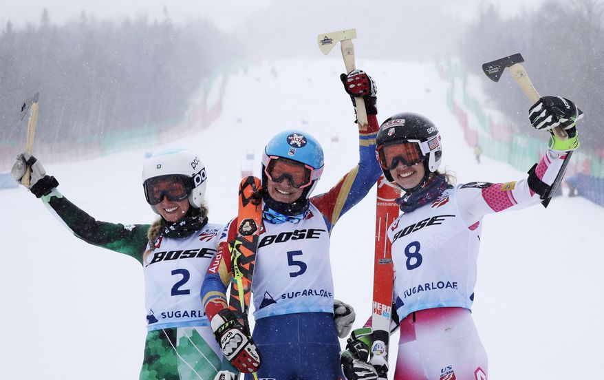 Megan McJames, of Park City, Utah, (5) raises the golden hatchet trophy after winning the women's giant slalom skiing race at the U.S. Alpine Ski Championships at Sugarloaf Mountain Resort in Carrabassett Valley, Maine, Monday, March 27, 2017. With McJames are second place finisher Foreste Peterson (2) and third place finisher Patricia Mangan (8). (AP Photo/Charles Krupa)
