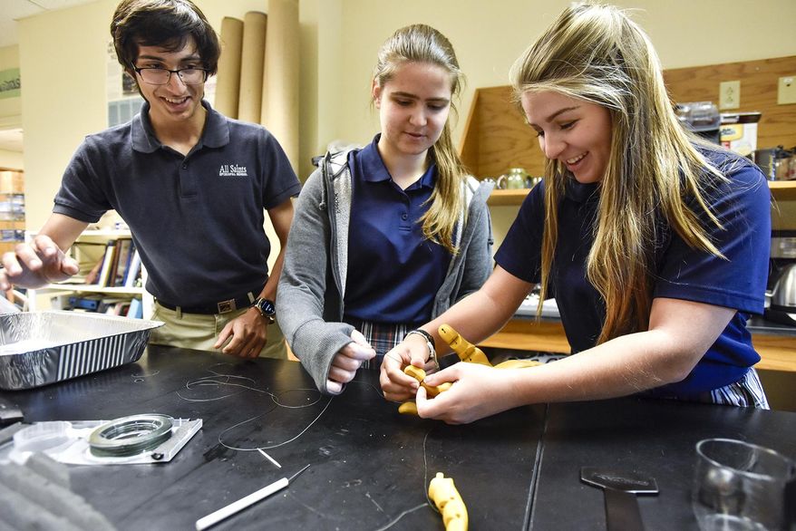ADVANCE FOR MONDAY APRIL 3 AND THEREAFTER - In a Tuesday, March 21, 2017 photo, Kevin Scott, Liza Naydanova and Jordan Smith work on a 3-D-printed prosthetic at All Saints Episcopal School in Tyler, Texas. The students are part of a group making a prosthetic arm and hand in partnership with the Center for Affordable Prosthetics that will eventually be used by Osman, a 22-year-old man who lives in Honduras.The students are part of a group making a prosthetic arm and hand in partnership with the Center for Affordable Prosthetics that will eventually be used by Osman, a 22-year-old man who lives in Honduras. (Chelsea Purgahn/Tyler Morning Telegraph via AP)