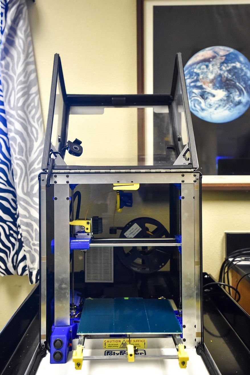 ADVANCE FOR MONDAY APRIL 3 AND THEREAFTER - A Tuesday, March 21, 2017 photo shows a 3-D printer at All Saints Episcopal School in Tyler, Texas. The students are part of a group making a prosthetic arm and hand in partnership with the Center for Affordable Prosthetics that will eventually be used by Osman, a 22-year-old man who lives in Honduras. (Chelsea Purgahn/Tyler Morning Telegraph via AP)