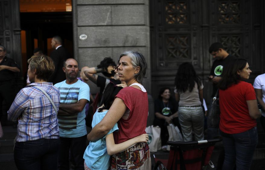 Veronica Fuertes embraces her daughter Violeta Penalba, who suffers epilepsy, and is treated with marijuana, as they stand outside the Senate in Buenos Aires, Argentina, Wednesday, March 29, 2017. The Senate is expected to vote into law the medicinal use of marijuana on Wednesday. (AP Photo/Natacha Pisarenko)