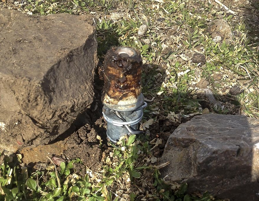 FILE - This Thursday, March 16, 2017 file photo released by the Bannock County Sheriff's Office shows an M-44 cyanide device in Pocatello, Idaho It's spring-activated and shoots poison that is meant to kill predators. Environmental groups have petitioned the U.S. Agriculture Department to ban its use of the devices aimed at killing coyotes after one went off near a boy and his dog earlier this month, killing the dog. The petition filed late Tuesday, March 28, 2017 by the Western Watersheds Project and other groups starts a formal process to prevent the department from using the devices across Idaho and mandate existing device removal. (Bannock County Sheriff's Office via AP, File)