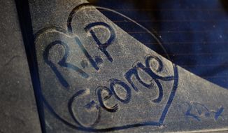 FILE - In this file photo dated Tuesday, Dec. 27, 2016, a message written by a fan on a dusty car window outside the home of British musician George Michael in London.  A private funeral took place Wednesday March 29, 2017, at Highgate Cemetery, north London, according to a statement released by Michael’s publicity agency, Connie Filippello Publicity, saying the funeral was attended by family and close friends. (AP Photo/Frank Augstein, FILE)