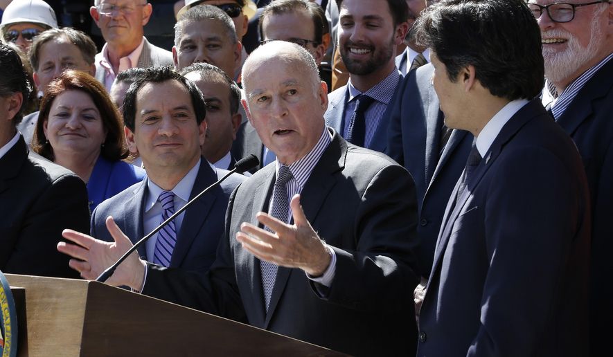 Calif., Gov. Jerry Brown, second from right, answers a questions concerning a plan to raise $52 billion to fix California roads, during a news conference Wednesday, March 29, 2017, in Sacramento, Calif. The 10-year plan would boost the gasoline excise tax by 12 cents a gallon along with higher registration fees and a $100 charge on emission-free vehicles. Brown was flanked by Assembly Speaker Anthony Rendon, D-Paramount, third from left, and Senate President Pro Tem Kevin de Leon, D-Los Angeles, right as well as other lawmakers, and supporters of the plan.(AP Photo/Rich Pedroncelli)