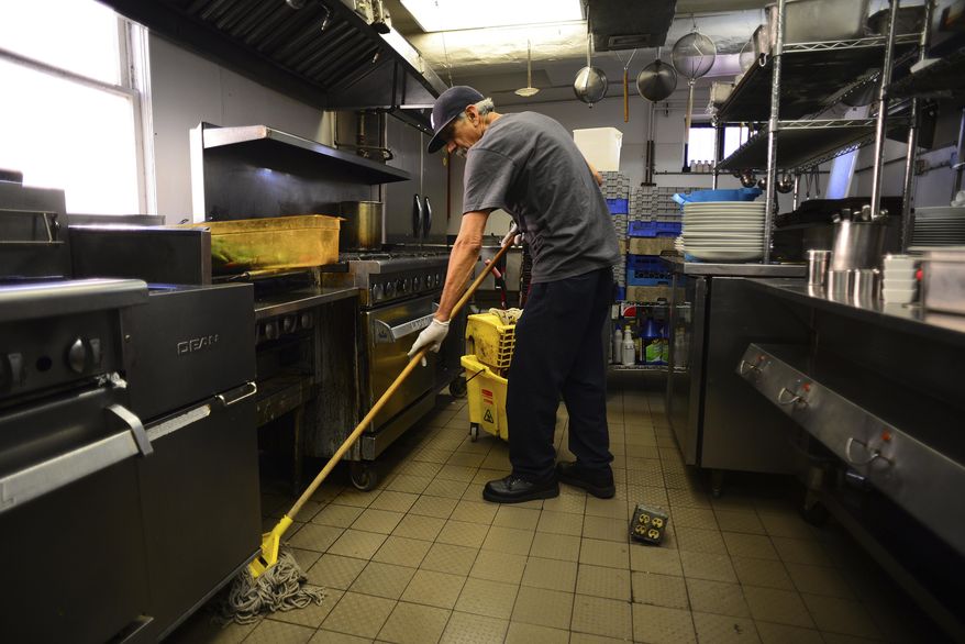 In this March 21, 2017, photo, Pablo Garcia a native of Chihuahua, Mexico, mops the kitchen at Sazon Restaurant in Santa Fe, N.M. “Without immigrants, our labor force would essentially stop growing, making it very difficult to increase our gross domestic product,” said New Mexico State University economist Jim Peach. (Adolphe Pierre-Louis/The Albuquerque Journal via AP)