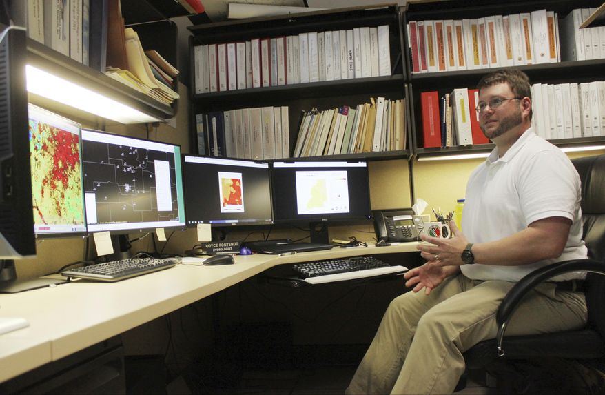 National Weather Service hydrologist Royce Fontenot poses for a photograph after discussing soil moisture levels, high temperatures and a lack of rain as reasons for flash drought during an interview in his office in Albuquerque, N.M., on Tuesday, March 28, 2017. A quick uptick in temperatures and no precipitation combined for a flash drought over part of New Mexico in March. (AP Photo/Susan Montoya Bryan)
