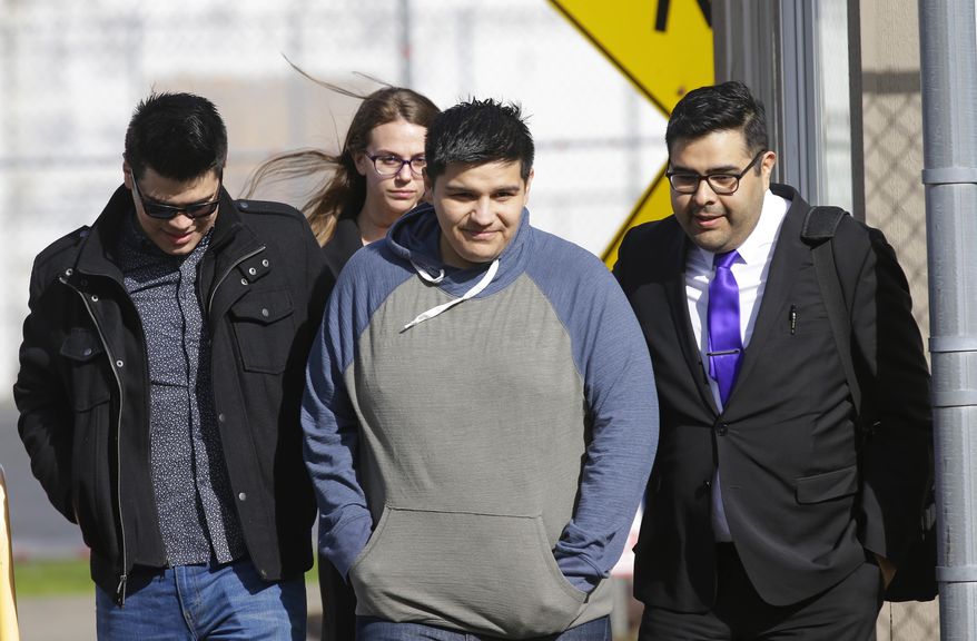 Daniel Ramirez Medina, second from right, walks out of the Northwest Detention Center in Tacoma, Wash., with his attorney, Luis Cortes, right, and his brother, left, who has not been identified by name, after Ramirez was released from federal custody, Wednesday, March 29, 2017. Ramirez had spent more than six weeks in immigration detention despite his participation in a program designed to prevent the deportation of those brought to the U.S. illegally as children. (AP Photo/Ted S. Warren)