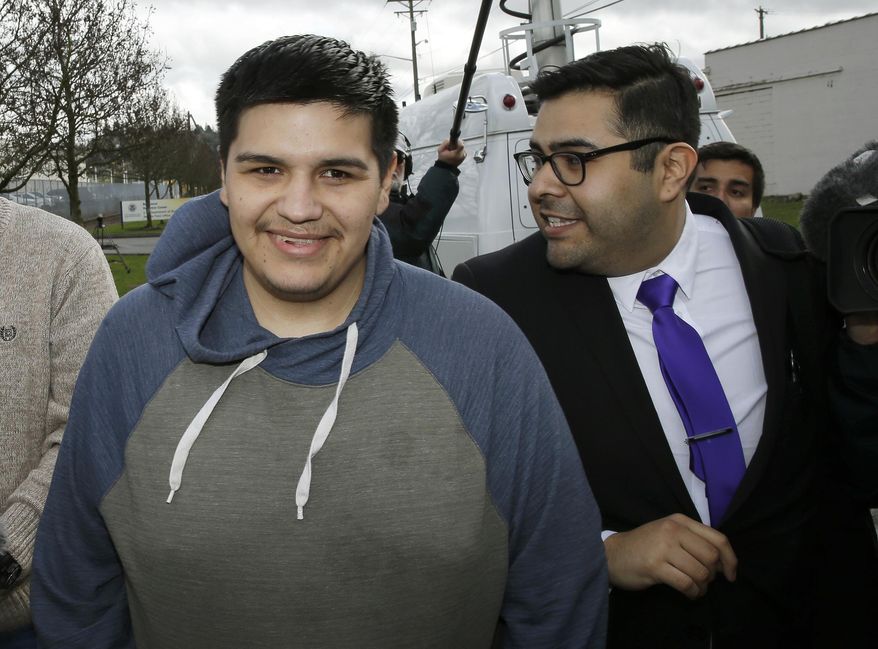 Daniel Ramirez Medina, left, walks with with his attorney, Luis Cortes, right, after Ramirez was freed from custody at the Northwest Detention Center in Tacoma, Wash., Wednesday, March 29, 2017. Ramirez had spent more than six weeks in immigration detention despite his participation in a program designed to prevent the deportation of those brought to the U.S. illegally as children. (AP Photo/Ted S. Warren)