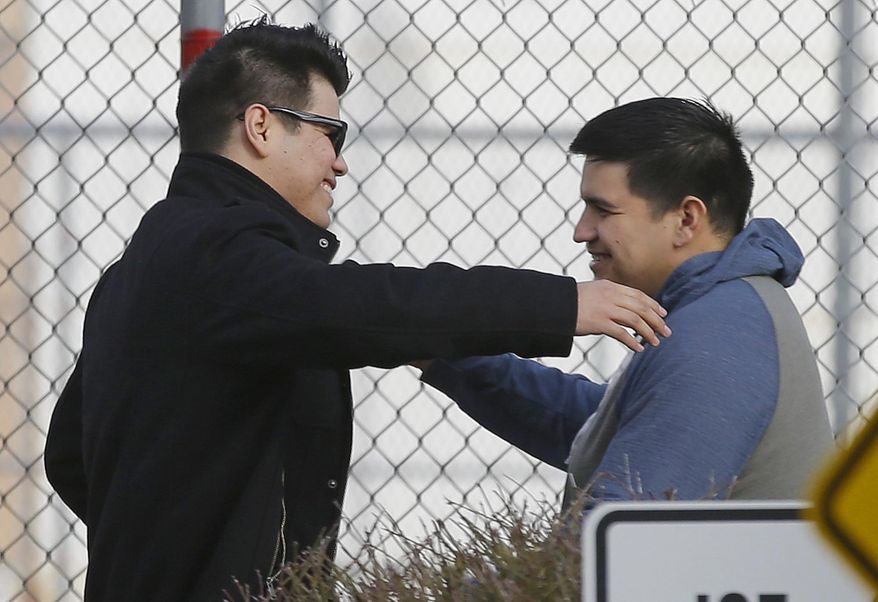 Daniel Ramirez Medina, right, hugs his brother, left, who has not been identified by name, after Ramirez walked out of the Northwest Detention Center in Tacoma, Wash., after Ramirez was released from federal custody, Wednesday, March 29, 2017. Ramirez had spent more than six weeks in immigration detention despite his participation in a program designed to prevent the deportation of those brought to the U.S. illegally as children. (AP Photo/Ted S. Warren)