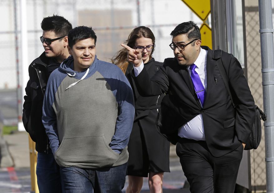 Daniel Ramirez Medina, second from left, walks out of the Northwest Detention Center in Tacoma, Wash., Wednesday, March 29, 2017, with his attorney, Luis Cortes, right, and his brother, left, who has not been identified by name, after Ramirez was released from federal custody. Ramirez had spent more than six weeks in immigration detention despite his participation in a program designed to prevent the deportation of those brought to the U.S. illegally as children. (AP Photo/Ted S. Warren)