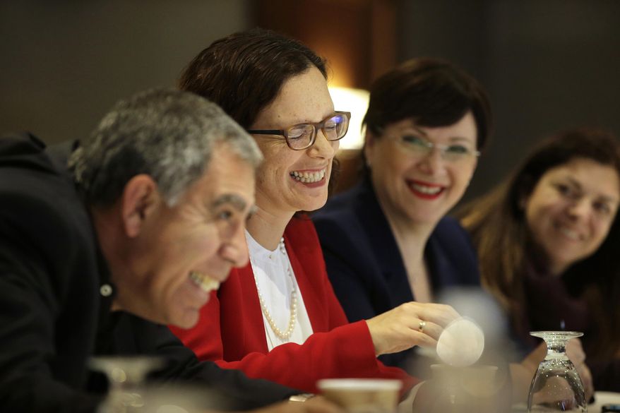 In this Tuesday, March 28, 2017 photo Israeli Knesset lawmakers, from the left, Mickey Levy, of the Yesh Atid party, Rachel Azaria, of the Kulanu party, and Tali Ploskov, also of the Kulanu party, laugh during an interview with a reporter from The Associated Press, in Boston. The lawmakers are to participate Wednesday, March 29, in a town hall at a synagogue, in Brookline, Mass., to discuss anti-Semitism in the U.S., among other issues. Limor Rubin, a non-profit program director, is seated at right. (AP Photo/Steven Senne)