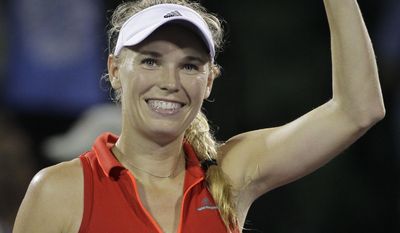 Caroline Wozniacki, of Denmark, waves at the crowd after defeating Lucie Safarova, of the Czech Republic, 6-4, 6-3 during the Miami Open tennis tournament, Tuesday, March 28, 2017, in Key Biscayne, Fla. (AP Photo/Luis M. Alvarez)