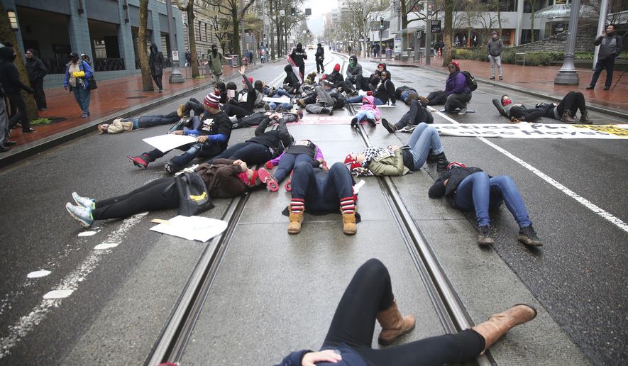 People protest the fatal police shooting of Quanice Hayes, a 17-year-old black teenager, on Wednesday, March 29, 2017, in Portland, Ore. A Multnomah County grand jury concluded last week that Officer Andrew Hearst was justified in shooting Hayes three times after police say Hayes reached for his waistband instead of following orders to surrender. (Stephanie Yao Long/The Oregonian via AP) ** FILE **