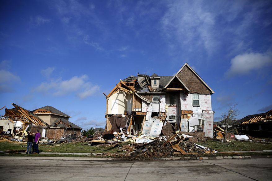 Houses are damaged following a storm early in the morning in Rockwall, Texas on Wednesday, March 29, 2017. A powerful storm system with winds exceeding 60 mph has damaged homes in suburban Dallas, knocked out power to tens of thousands across Texas and brought heavy rain that inundated some areas. (Rose Baca/The Dallas Morning News via AP)