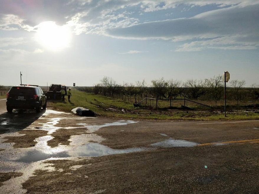 Texas Department of Public Safety troopers investigate a two-vehicle crash that left several storm chasers dead Tuesday, March 28, 2017, near Spur, Texas. The storms spawned multiple funnel clouds and an occasional tornado in open areas of West Texas on Tuesday afternoon. The crash happened at a remote intersection near the town of Spur, about 55 miles southeast of Lubbock. (Ellysa Gonzalez/Lubbock Avalanche-Journal via AP)