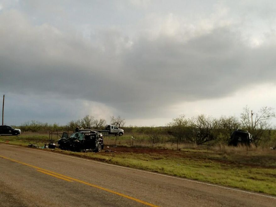 Texas Department of Public Safety troopers investigate a two-vehicle crash that left several storm chasers dead Tuesday , March 28, 2017, near Spur, Texas. Tornadoes had been reported nearby at the time of the crash and heavy rain had been reported in the area, according to the National Weather Service. (Ellysa Gonzalez/Lubbock Avalanche-Journal via AP)