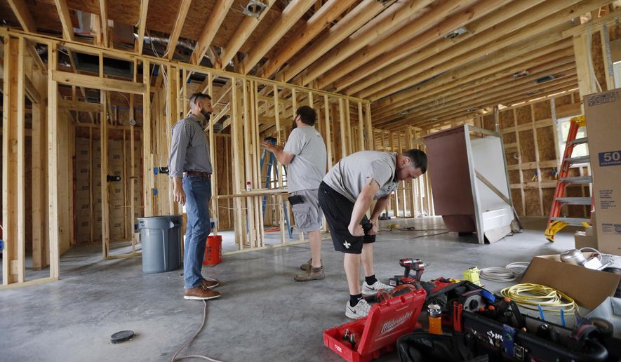 In this Friday, March 24, 2017, photo, Zach Tyson, left, owner of Tyson Construction, talks to electricians in a home he is constructing in Destrahan, La. General contractors and other small businesses in the remodeling industry can look forward to strong growth in the coming years, but the big force behind that business may be surprising: baby boomers. Tyson estimates that between 30 percent and 40 percent of his revenue is coming from boomer renovations, up from 15 percent to 20 percent five years ago. (AP Photo/Gerald Herbert)