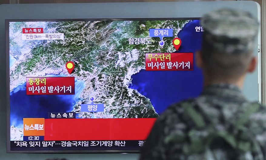 FILE - In this Sept. 9, 2016 file photo, a South Korean marine watches a TV screen reporting about North Korea's possible nuclear test at the Seoul Railway Station in Seoul, South Korea. North Korea has conducted five nuclear tests, the first in 2006. All were conducted in the depths of Mount Mantap, a nondescript granite peak in the remote and heavily forested Hamgyong mountain range about 80 kilometers (50 miles) as the crow flies from Chongjin, the nearest big city. Since North Korea is the only country in the world that still conducts nuclear weapons tests, its Punggye-ri site on _ or mostly under _ Mount Mantap is also the world’s only active nuclear testing site. The letters on the screen read: "Explosion suspect." (Kim Ju-sung/Yonhap via AP, File)
