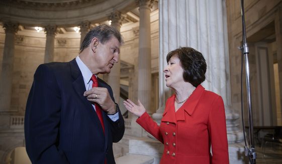 In this March 28, 2017, file photo, Sen. Joe Manchin, D-W. Va., left, and Sen. Susan Collins, R-Maine, who serve together on the Senate Appropriations Committee and the Senate Intelligence Committee, confer on Capitol Hill after doing television news interviews, in Washington. (AP Photo/J. Scott Applewhite, file)