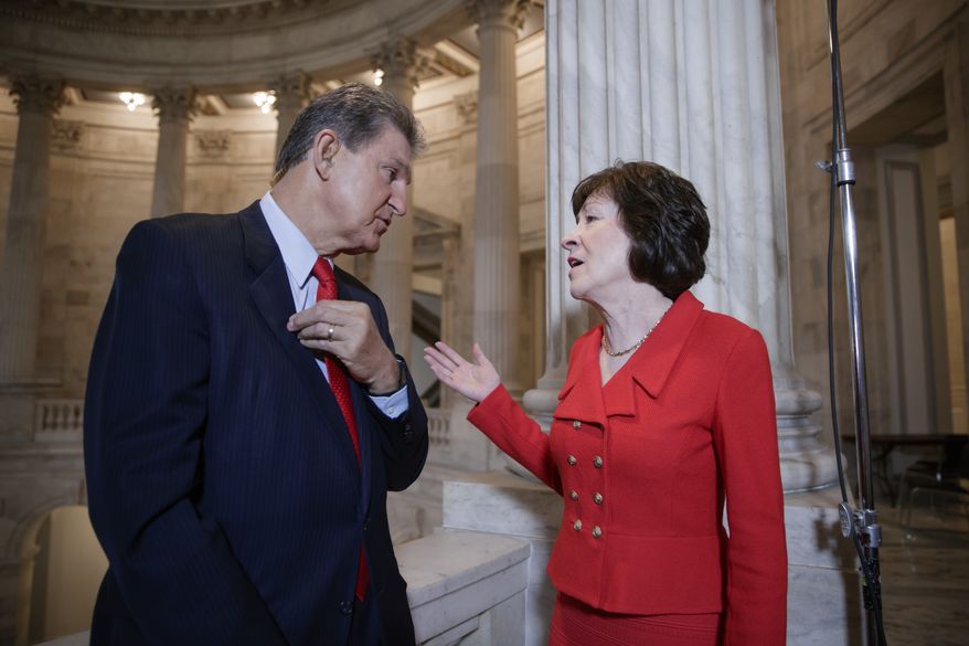 In this March 28, 2017, file photo, Sen. Joe Manchin, D-W. Va., left, and Sen. Susan Collins, R-Maine, who serve together on the Senate Appropriations Committee and the Senate Intelligence Committee, confer on Capitol Hill after doing television news interviews, in Washington. (AP Photo/J. Scott Applewhite, file)