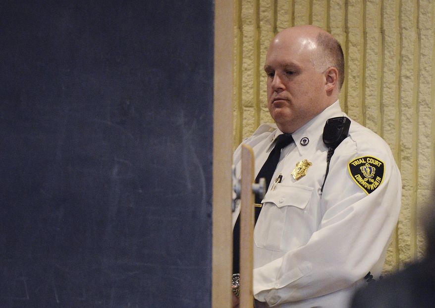 ADDS FIRST NAME OF VICTIM - Brian G. Brito, 21, of Manchester, N.H., is hidden behind a chalkboard during his arraignment in Lynn District Court in Lynn, Mass., Thursday, March 30, 2017. Brito is charged with murdering 24-year-old Mohammedreza Sina Zangiband. The driver for Atha's Famous Roast Beef was found shot multiple times inside his vehicle just before 6 p.m. Monday, March 27. (Paul Bilodeau/The Salem News via AP, Pool)