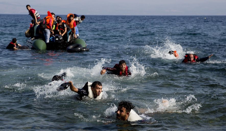 FILE - In this Sunday, Sept. 20, 2015 file photo, migrants whose boat stalled at sea while crossing from Turkey to Greece swim to approach the shore of the island of Lesbos, Greece. (AP Photo/Petros Giannakouris, File)