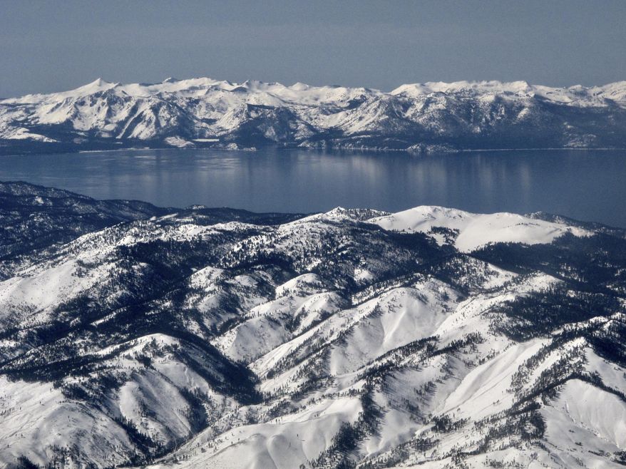 In this photo taken March 2, 2017, record winter snowfall is seen in the mountains around Lake Tahoe, in this aerial photo taken from above the Washoe Valley just south of Reno, Nev. Surveyors will crunch across the deepest mountain snowdrifts California has seen in years on Thursday, March 30, 2017, to take the first snow measurement of the spring, a time when the snow begins to melt and flow downhill. (AP Photo/Scott Sonner)