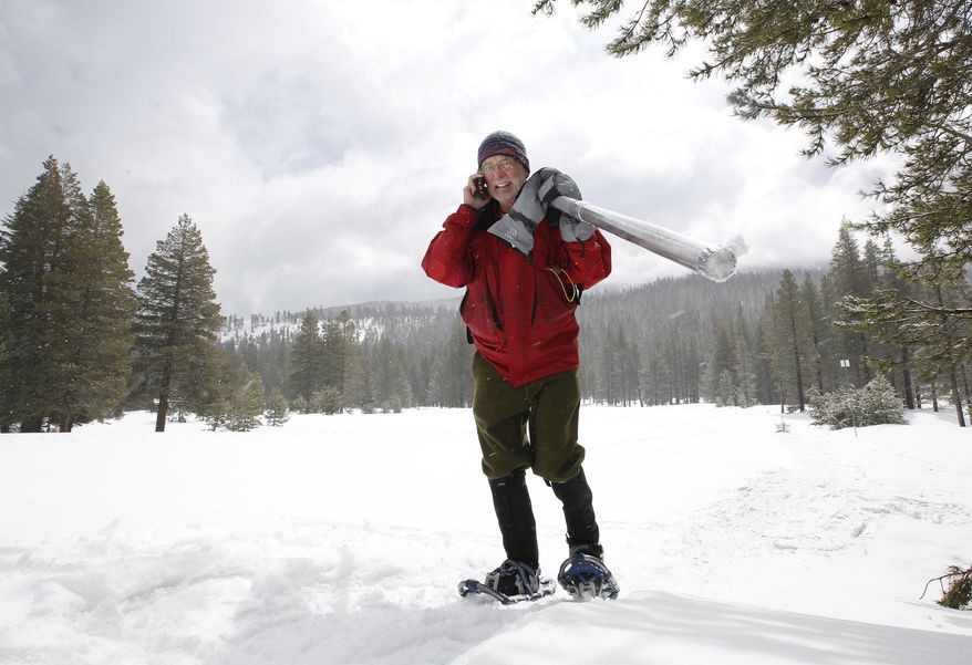 Frank Gehrke, chief of the California Cooperative Snow Surveys Program for the Department of Water Resources, takes a phone call as he returns from doing the manual snow survey at Phillips Station, Thursday, March 30, 2017, near Echo Summit, Calif. The survey found the snowpack's water content at 183 at percent of normal for this location at this time of year. Overall, the state's electronic snow monitors show the Sierra Nevada snowpack at 164 percent of normal. (AP Photo/Rich Pedroncelli)