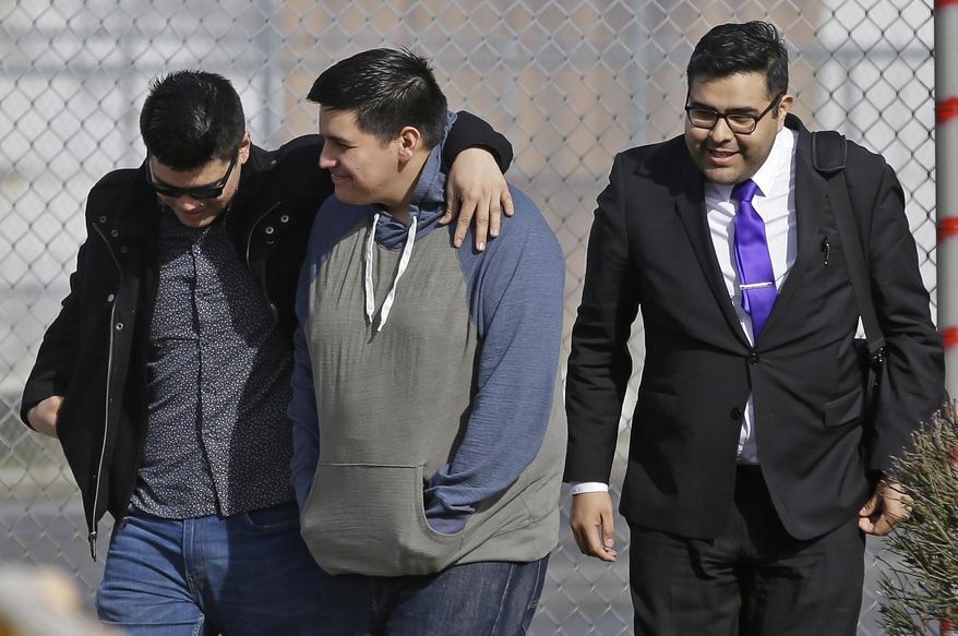 Daniel Ramirez Medina, center, walks out of the Northwest Detention Center in Tacoma, Wash., with his attorney, Luis Cortes, right, and his brother, left, who has not been identified by name, after Ramirez was released from federal custody, Wednesday, March 29, 2017. Ramirez had spent more than six weeks in immigration detention despite his participation in a program designed to prevent the deportation of those brought to the U.S. illegally as children. (AP Photo/Ted S. Warren)