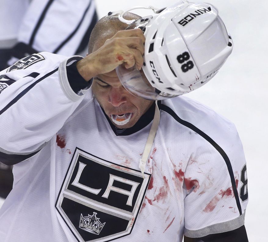 Los Angeles Kings' Jarome Iginla goes to the penalty box after a fight with Calgary Flames' Deryk Engelland during the first period of an NHL hockey game in Calgary, Alberta, Wednesday, March 29, 2017. (Larry MacDougal/The Canadian Press via AP)