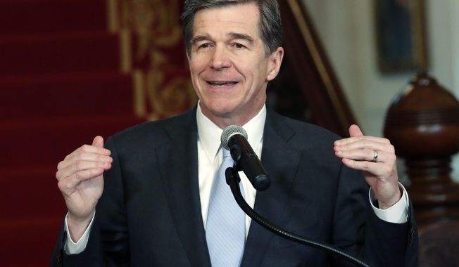 North Carolina Gov. Roy Cooper holds a press conference at the Executive Mansion in Raleigh, N.C., Thursday, March 30, 2017, to announce that he signed a HB142, a compromise replacement bill for HB2, that the N.C. General Assembly passed earlier in the day. (Chris Seward/The News &amp;amp; Observer via AP)