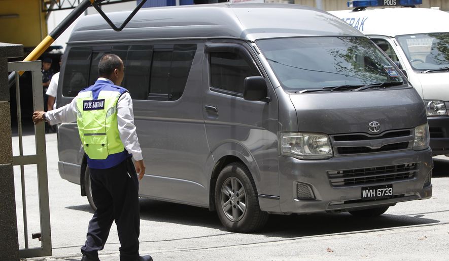 An unidentified van believed to be carrying the body of Kim Jong Nam comes out from the forensic department at Kuala Lumpur Hospital in Kuala Lumpur, Malaysia Thursday, March 30, 2017. Malaysian police on Thursday stopped guarding the morgue that held the body of North Korean leader Kim Jong Un’s murdered half-brother, after the van departed amid reports that his remains will leave the country. Shortly after the van left the hospital, police left the building and the morgue was reopened to the public.(AP Photo/Daniel Chan)