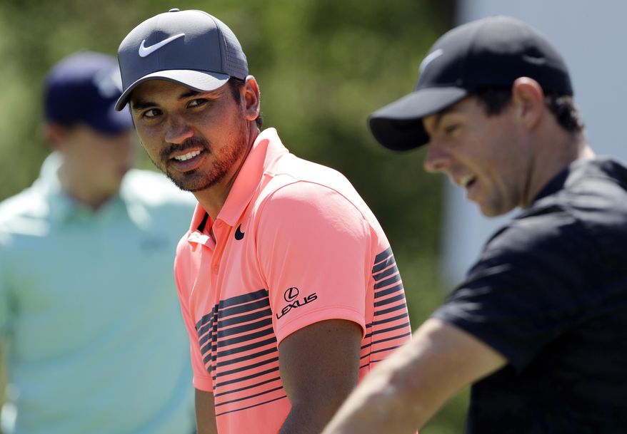 FILE - In this March 21, 2017, file photo, Jason Day, of Australia, left, talks with Rory McIlroy, of Northern Ireland, right, as they practice for the Dell Technologies Match Play Championship golf tournament at Austin County Club in Austin, Texas. (AP Photo/Eric Gay, File)