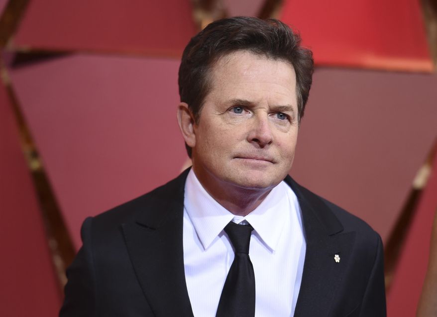 FILE - In this Feb. 26, 2017, file photo, Michael J. Fox arrives at the Oscars at the Dolby Theatre in Los Angeles. Fox told AARP The Magazine in an interview released on March 30, 2017, that an effort to repeal the Affordable Care Act and cut Medicare isn’t politics, but rather, “that’s our lives.” (Photo by Richard Shotwell/Invision/AP, File)