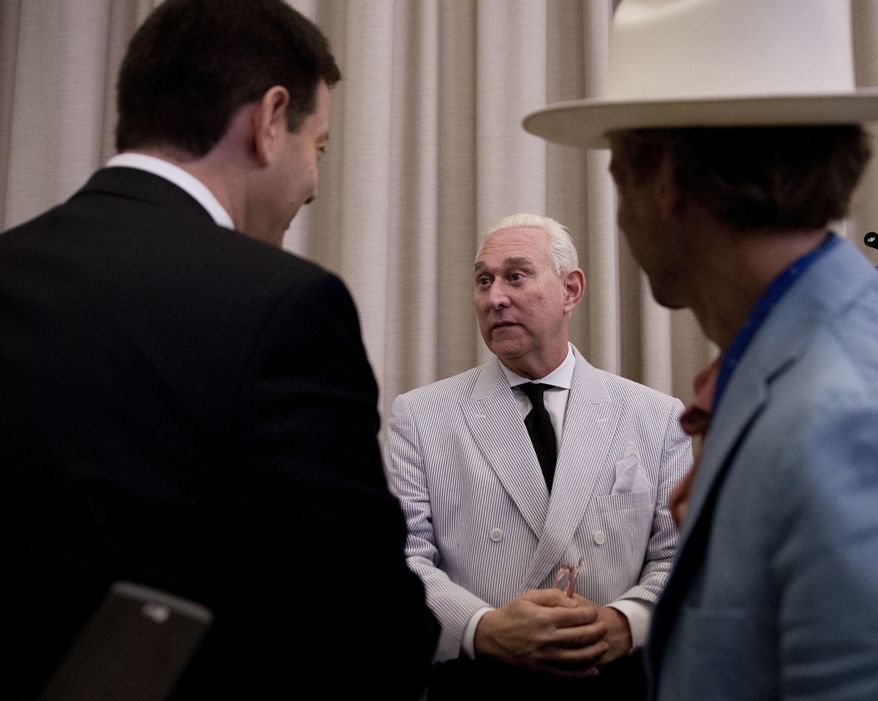 FILE- In this July 16, 2016 file photo, Roger Stone, center, then an adviser to Donald Trump, speaks to reporters in New York. A lawyer for Republican operative Stone says his client is so busy preparing for a possible grilling by the U.S. Senate intelligence committee, that he doesn’t have time to attend the opening of his civil defamation trial in New York City. Stone was subpoenaed to testify this week, but his lawyer asked the judge for a delay on Wednesday. The judge denied that request. (AP Photo/Mary Altaffer, File)