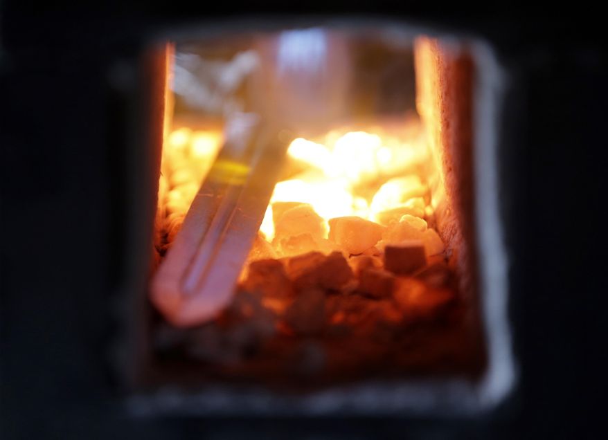 John Lundemo heats a sword in his forge at his workshop in New Hampton, N.Y., Thursday, March 2, 2017. He educated himself on the finer points of edge geometry, metal tempering and distal tapering, which refers to the blade getting thinner from guard to tip. (AP Photo/Seth Wenig)