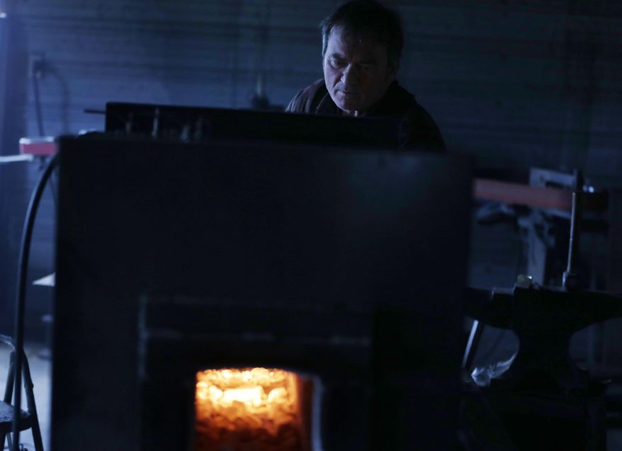 John Lundemo heats a sword in his forge at his workshop in New Hampton, N.Y., Thursday, March 2, 2017. (AP Photo/Seth Wenig)