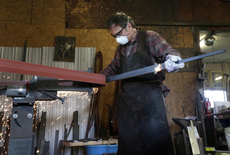 John Lundemo works on an unfinished sword at his workshop in New Hampton, N.Y., Thursday, March 2, 2017. (AP Photo/Seth Wenig)