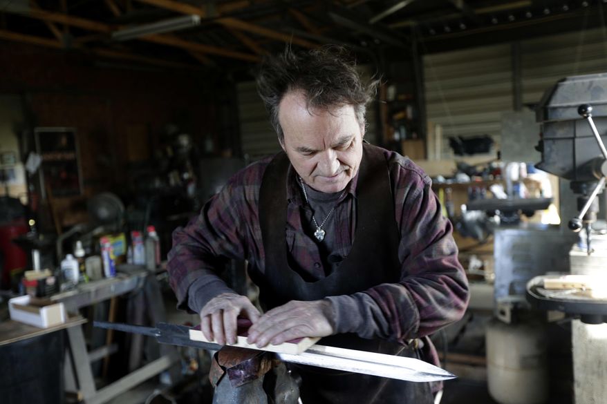 John Lundemo works on an unfinished sword at his workshop in New Hampton, N.Y., Thursday, March 2, 2017. (AP Photo/Seth Wenig)