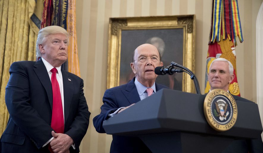 Secretary of Commerce Wilbur Ross, center, accompanied by President Donald Trump, left, and Vice President Mike Pence, right, speaks during a signing ceremony for executive orders regarding trade in the Oval Office at the White House, Friday, March 31, 2017, in Washington. Trump spoke to the media but left before signing the orders. (AP Photo/Andrew Harnik)
