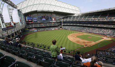 FILE - In this April 4, 2015, file photo, the roof of Minute Maid ballpark is wide open for an exhibition baseball game between the Houston Astros and the Kansas City Royals, in Houston. Over two-thirds of all major league teams now play in facilities that opened in 1992 or later, part of a ballpark boom that has changed how fans and players experience the game _ and has led to some contentious debate over how to pay for it all.  (AP Photo/Pat Sullivan, File)