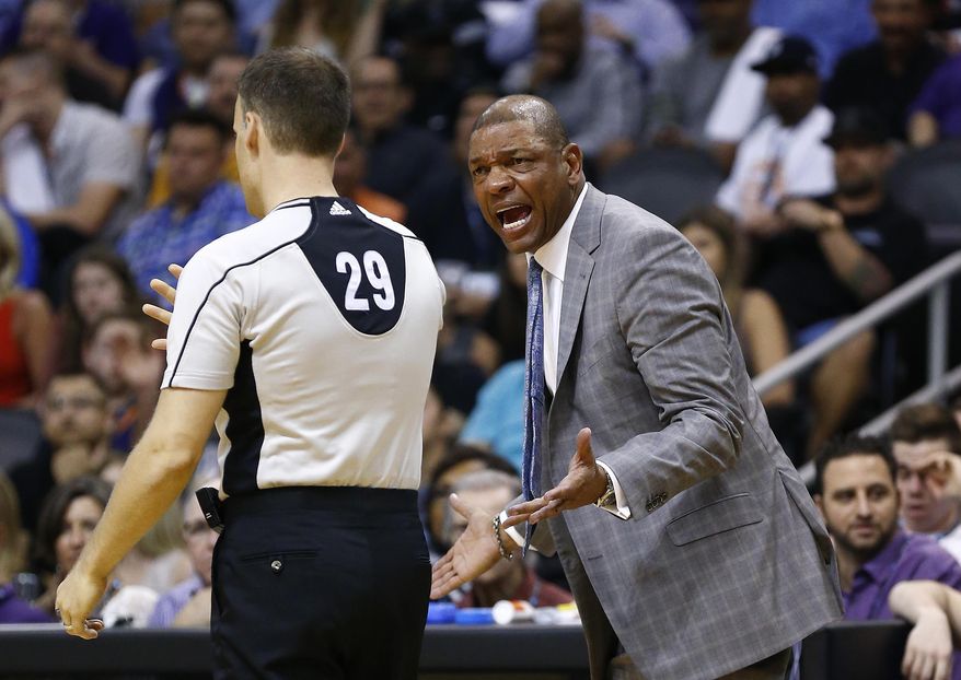 Los Angeles Clippers head coach Doc Rivers, right, argues with referee Mark Lindsay (29) during the first half of an NBA basketball game against the Phoenix Suns Thursday, March 30, 2017, in Phoenix. (AP Photo/Ross D. Franklin)