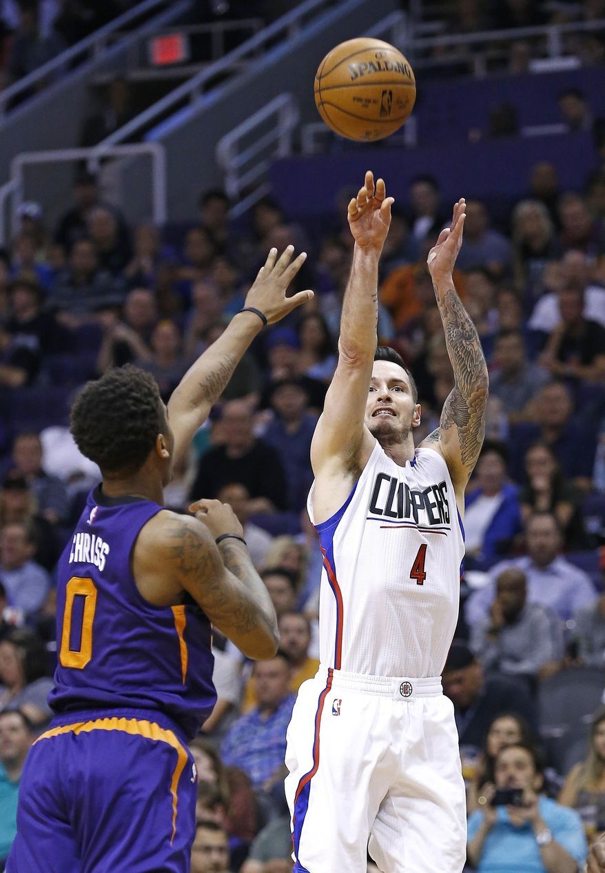 Los Angeles Clippers' JJ Redick (4) shoots over Phoenix Suns' Marquese Chriss (0) during the first half of an NBA basketball game Thursday, March 30, 2017, in Phoenix. (AP Photo/Ross D. Franklin)