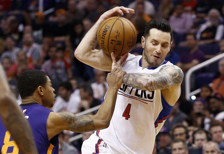 Phoenix Suns' Tyler Ulis, left, strips the ball from Los Angeles Clippers' JJ Redick (4) during the first half of an NBA basketball game Thursday, March 30, 2017, in Phoenix. (AP Photo/Ross D. Franklin)