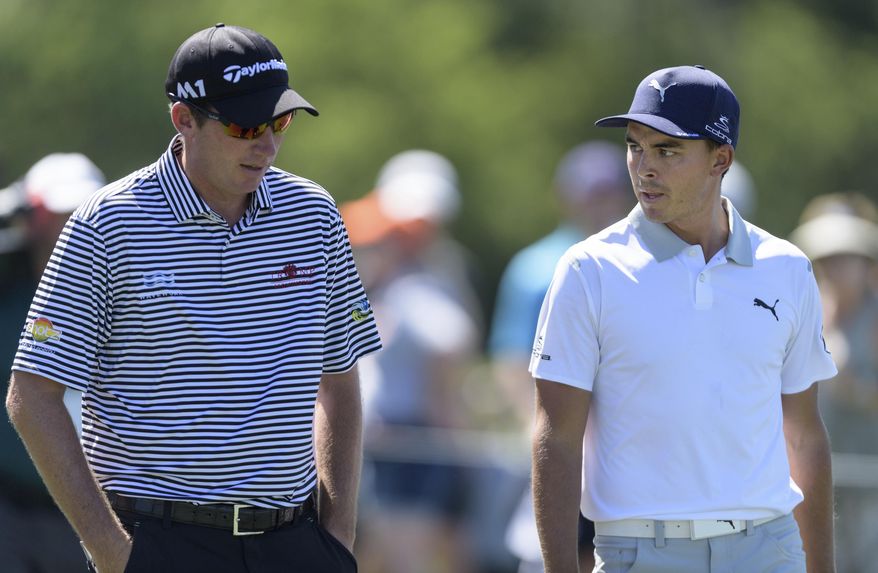 Defending champion Jim Herman, left, and Rickie Fowler talk after leaving the eighth tee box during the second round of the Shell Houston Open golf tournament Friday, March 31, 2017, at The Golf Club of Houston in Humble, Texas. (Wilf Thorne/Houston Chronicle via AP)