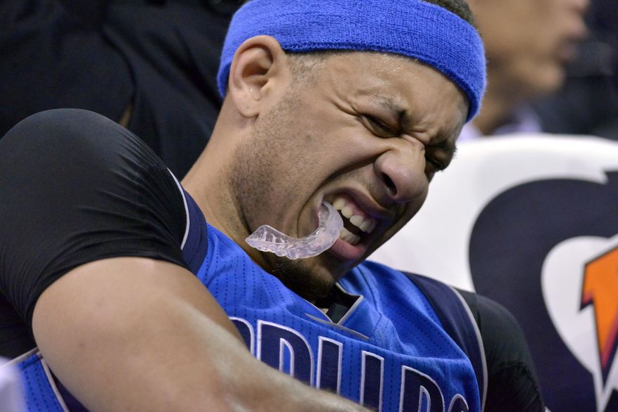 Dallas Mavericks guard Seth Curry grimaces and holds his arm after leaving the court in the second half of an NBA basketball game against the Memphis Grizzlies, Friday, March 31, 2017, in Memphis, Tenn. (AP Photo/Brandon Dill)