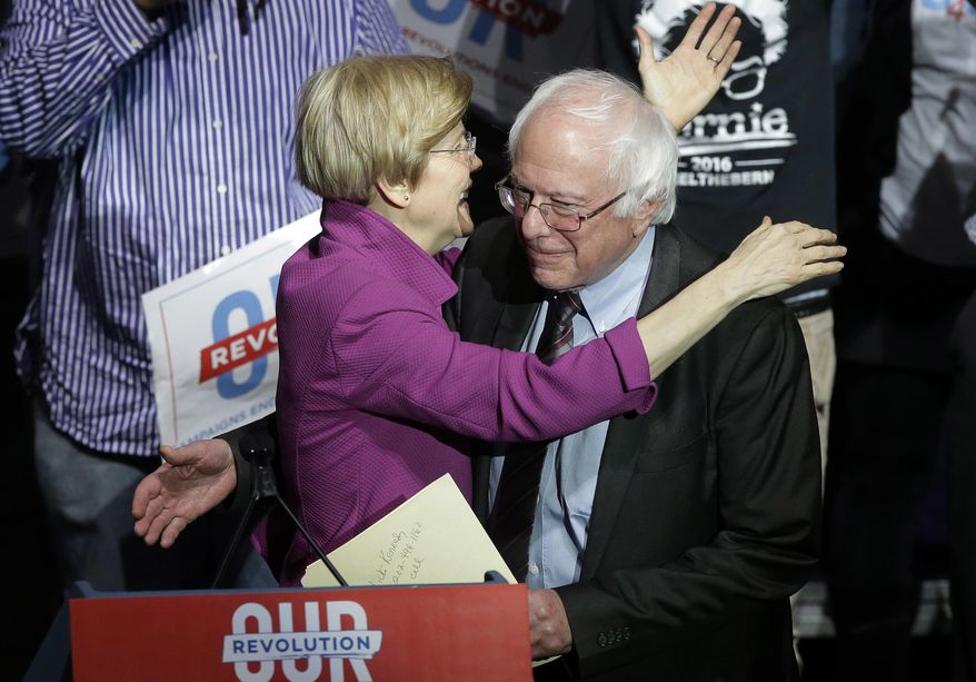Sens.s Elizabeth Warren, D-Mass., left, and Bernie Sanders, I-Vt., right, embrace during a rally Friday, March 31, 2017, in Boston. Sanders and Warren are making a joint appearance at the evening rally in Boston as liberals continue to mobilize against the agenda of Republican President Donald Trump. (AP Photo/Steven Senne)