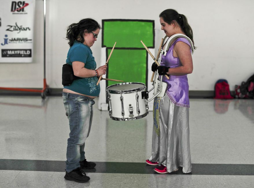 In this March 22, 2017, photo, members of the FREE Players Drum Corps practice their technique before a rehearsal in Old Bethpage, N.Y. The 65-member band is composed entirely of adults with intellectual and physical disabilities. They've performed at Disney World and marched in New York City's Columbus Day Parade. (AP Photo/Julie Jacobson)